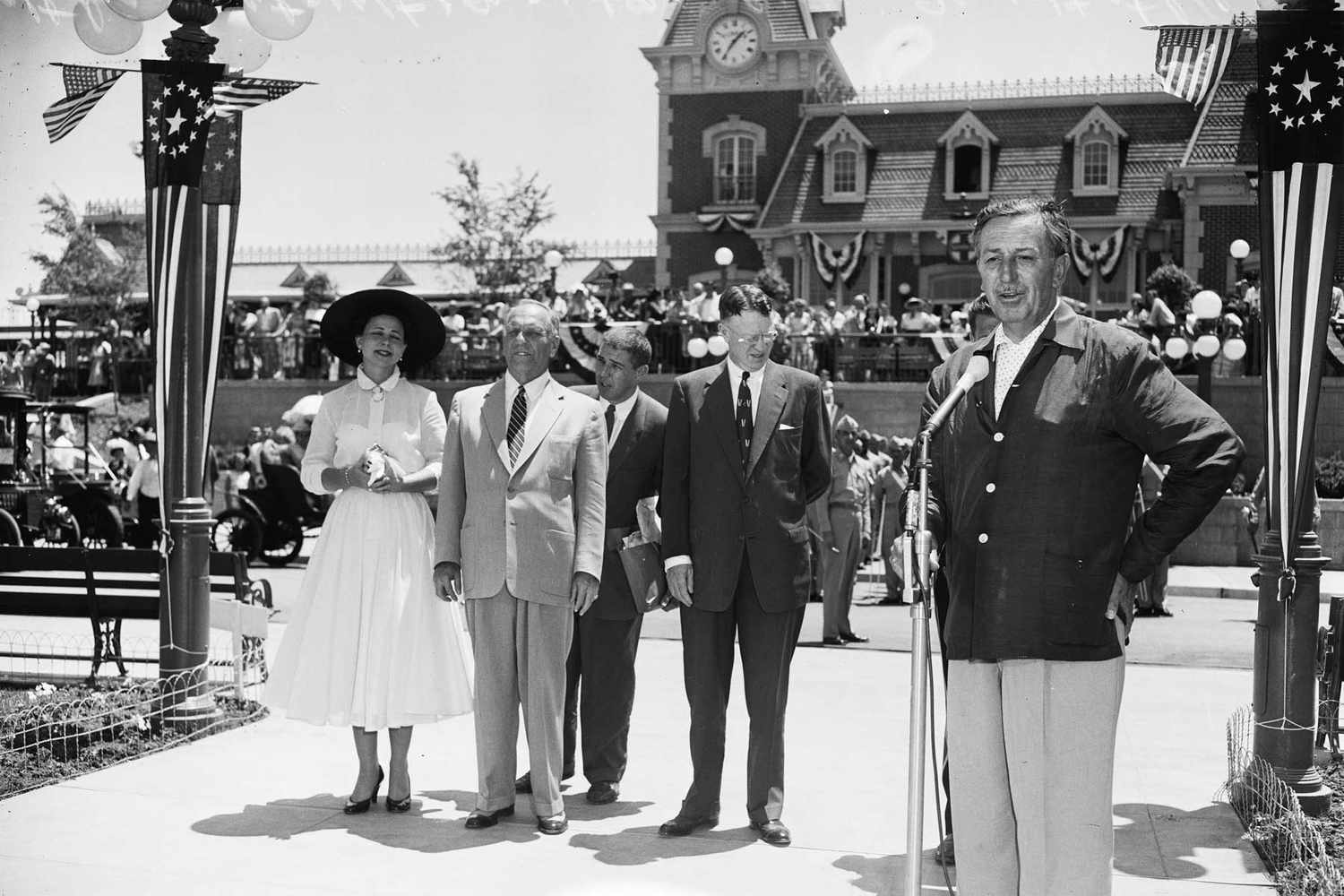 Walt Disney pointing at a map of Disneyland